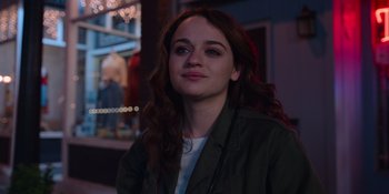 Movie still from “The In Between” (2022), directed by Arie Posin – A woman with long brown curly hair wearing a green jacket; Close Up shot, Over the shoulder angle