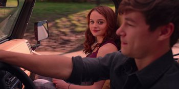 Movie still from “The In Between” (2022), directed by Arie Posin – A young woman sitting next to a young man in a car; Medium shot, Over the shoulder angle