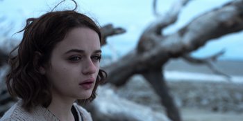 Movie still from “The In Between” (2022), directed by Arie Posin – A young woman is standing in front of a dead tree; Close Up shot, Low angle