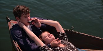 Movie still from “The In Between” (2022), directed by Arie Posin – A man and a woman are sitting on a boat; Medium shot, High angle