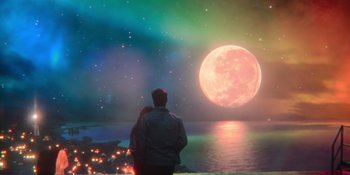 Movie still from “The In Between” (2022), directed by Arie Posin – A man and a woman standing in front of a full moon; Wide shot, Over the shoulder angle