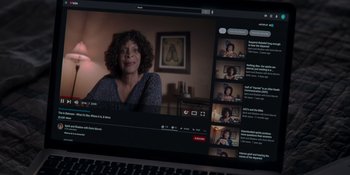 Movie still from “The In Between” (2022), directed by Arie Posin – A laptop screen showing a video of a woman in front of a fireplace; Extreme Close Up shot, Overhead angle