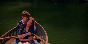 Movie still from “The In Between” (2022), directed by Arie Posin – A man and a woman sitting in a boat on the water; Medium shot, High angle