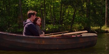 Movie still from “The In Between” (2022), directed by Arie Posin – A man and a woman sitting in a row boat on the water; Wide shot, High angle