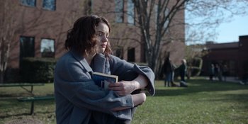 Movie still from “The In Between” (2022), directed by Arie Posin – A woman holding a book in her arms; Medium shot, Over the shoulder angle