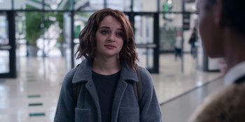 Movie still from “The In Between” (2022), directed by Arie Posin – A young woman with brown hair wearing a gray jacket; Close Up shot, Over the shoulder angle