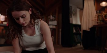 Movie still from “The In Between” (2022), directed by Arie Posin – A person sitting in a living room; Medium shot, Low angle