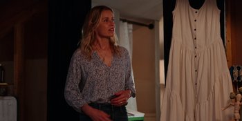 Movie still from “The In Between” (2022), directed by Arie Posin – A woman standing in front of a mirror in a room; Medium shot, Over the shoulder angle