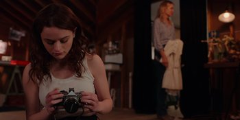 Movie still from “The In Between” (2022), directed by Arie Posin – A woman holding a camera while standing next to another woman; Medium shot, Over the shoulder angle