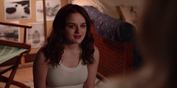 Movie still from “The In Between” (2022), directed by Arie Posin – A woman sitting on a bed in front of a wooden bed frame; Close Up shot, Over the shoulder angle