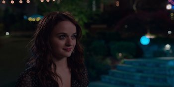 Movie still from “The In Between” (2022), directed by Arie Posin – A beautiful young lady standing in front of stairs at night; Close Up shot, Over the shoulder angle