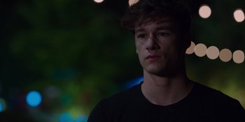 Movie still from “The In Between” (2022), directed by Arie Posin – A young man is looking into the distance; Close Up shot, Over the shoulder angle