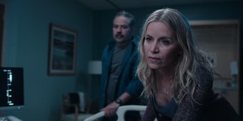 Movie still from “The In Between” (2022), directed by Arie Posin – A man and a woman standing in a dark room; Close Up shot, Over the shoulder angle