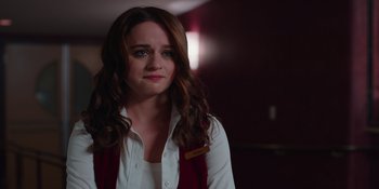 Movie still from “The In Between” (2022), directed by Arie Posin – A woman with long brown hair wearing a white shirt and a red vest; Close Up shot, Over the shoulder angle