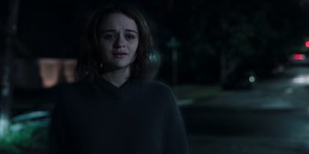 Movie still from “The In Between” (2022), directed by Arie Posin – A young woman is standing outside in the dark; Close Up shot, Over the shoulder angle