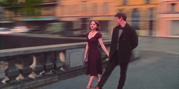 Movie still from “The In Between” (2022), directed by Arie Posin – A man and a woman walking down a street; Wide shot, Low angle