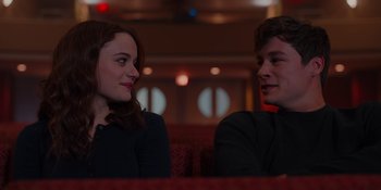 Movie still from “The In Between” (2022), directed by Arie Posin – A man and a woman sitting next to each other on a couch; Close Up shot, Over the shoulder angle