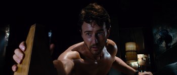 Movie still from “The Incredible Hulk” (2008), directed by Louis Leterrier – A man with a beard and blue eyes is posing for the camera; Close Up shot, Low angle