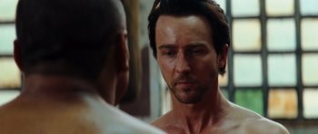 Movie still from “The Incredible Hulk” (2008), directed by Louis Leterrier – A person looking at a person in a mirror; Close Up shot, Over the shoulder angle