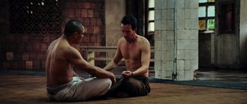 Movie still from “The Incredible Hulk” (2008), directed by Louis Leterrier – Two men sitting on the ground talking to each other; Medium shot, Over the shoulder angle