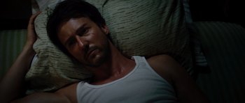 Movie still from “The Incredible Hulk” (2008), directed by Louis Leterrier – A person laying on a bed; Close Up shot, Overhead angle