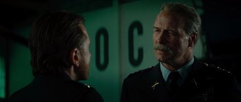 Movie still from “The Incredible Hulk” (2008), directed by Louis Leterrier – A man in a uniform talking to another man in a uniform; Close Up shot, Over the shoulder angle