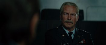 Movie still from “The Incredible Hulk” (2008), directed by Louis Leterrier – An older man in a military uniform looking at the camera; Close Up shot, Over the shoulder angle