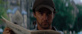 Movie still from “The Incredible Hulk” (2008), directed by Louis Leterrier – A person wearing a hat and reading a newspaper; Close Up shot, Low angle