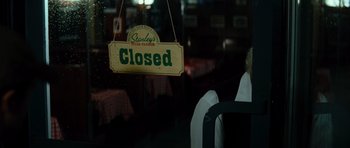 Movie still from “The Incredible Hulk” (2008), directed by Louis Leterrier – A closed sign hanging in a restaurant window; Close Up shot, Over the shoulder angle