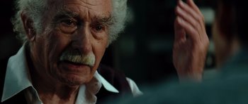 Movie still from “The Incredible Hulk” (2008), directed by Louis Leterrier – An old man with a mustache and a beard; Close Up shot, Over the shoulder angle
