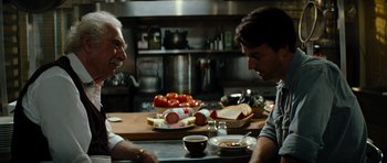 Movie still from “The Incredible Hulk” (2008), directed by Louis Leterrier – Two men sitting at a table in a kitchen; Close Up shot, Over the shoulder angle