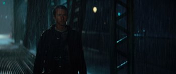 Movie still from “The Incredible Hulk” (2008), directed by Louis Leterrier – A man standing in the rain in the dark; Medium shot, Over the shoulder angle