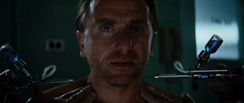 Movie still from “The Incredible Hulk” (2008), directed by Louis Leterrier – A person with his hands on his neck; Close Up shot, Low angle