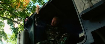 Movie still from “The Incredible Hulk” (2008), directed by Louis Leterrier – A man sitting in the back of a truck; Medium shot, Low angle