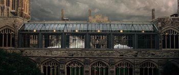 Movie still from “The Incredible Hulk” (2008), directed by Louis Leterrier – A man standing on top of a building near a window; Extreme Wide shot, High angle