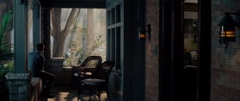 Movie still from “The Incredible Hulk” (2008), directed by Louis Leterrier – Two wicker chairs in front of a brick wall; Wide shot, High angle