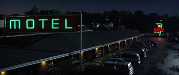 Movie still from “The Incredible Hulk” (2008), directed by Louis Leterrier – A motel sign is lit up at night; Extreme Wide shot, Low angle