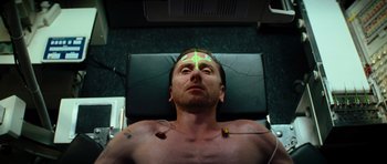 Movie still from “The Incredible Hulk” (2008), directed by Louis Leterrier – A man is sitting in a chair with wires attached to his head; Close Up shot, Overhead angle