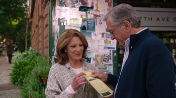 Movie still from “The Intern” (2015), directed by Nancy Meyers – An older man and a younger woman looking at a piece of paper; Medium shot, Over the shoulder angle