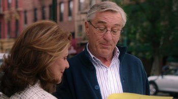 Movie still from “The Intern” (2015), directed by Nancy Meyers – An older man and a younger woman looking at something; Close Up shot, Over the shoulder angle