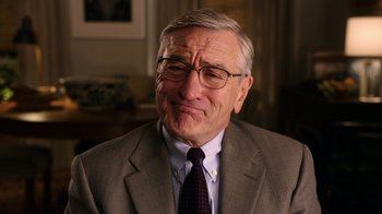 Movie still from “The Intern” (2015), directed by Nancy Meyers – An older man wearing a suit and tie; Close Up shot, Over the shoulder angle