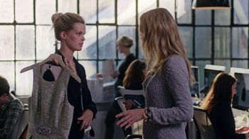 Movie still from “The Intern” (2015), directed by Nancy Meyers – Two women are conversing in an office setting; Medium shot, Over the shoulder angle