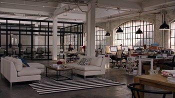 Movie still from “The Intern” (2015), directed by Nancy Meyers – A living room filled with lots of furniture and windows; Extreme Wide shot, High angle