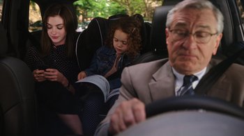 Movie still from “The Intern” (2015), directed by Nancy Meyers – Two girls and an older man in a car; Medium shot, Over the shoulder angle