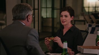 Movie still from “The Intern” (2015), directed by Nancy Meyers – A man and a woman sitting at a dinner table; Medium shot, Over the shoulder angle