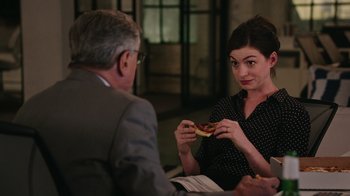 Movie still from “The Intern” (2015), directed by Nancy Meyers – A man and a woman sitting at a dinner table; Medium shot, Over the shoulder angle
