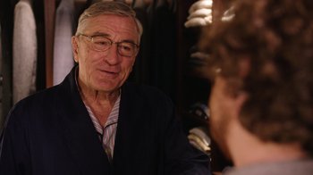 Movie still from “The Intern” (2015), directed by Nancy Meyers – An older man wearing glasses talking to a younger man; Medium shot, Over the shoulder angle