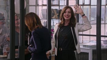 Movie still from “The Intern” (2015), directed by Nancy Meyers – Two women standing next to each other in front of a window; Medium shot, Over the shoulder angle