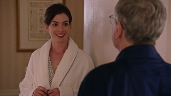 Movie still from “The Intern” (2015), directed by Nancy Meyers – A man and a woman in a bathrobe in front of a bathroom mirror; Medium shot, Over the shoulder angle