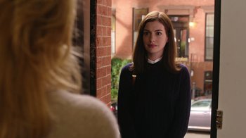 Movie still from “The Intern” (2015), directed by Nancy Meyers – A woman standing next to a brick wall; Medium shot, Over the shoulder angle